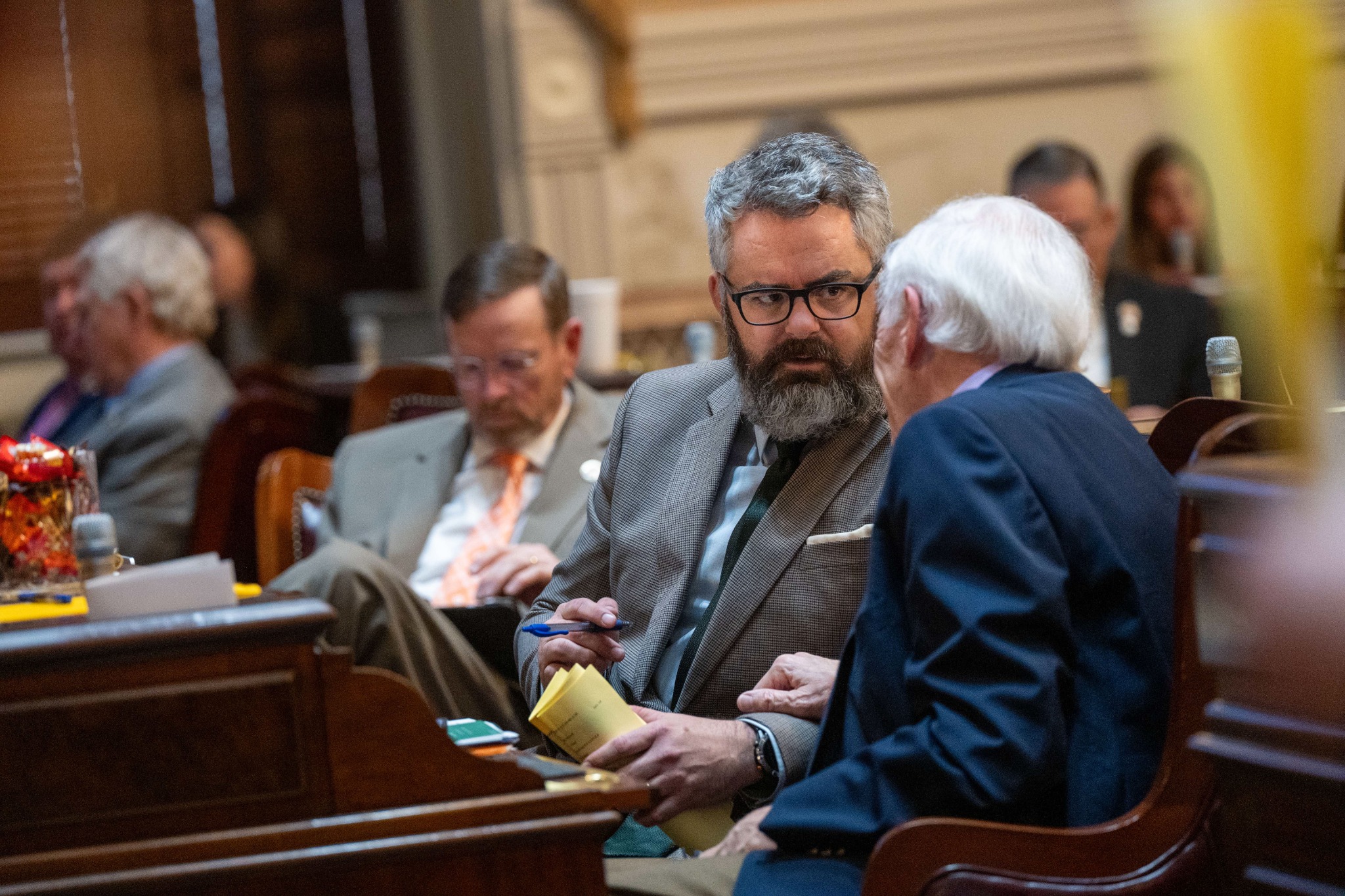 Micah Caskey working with a colleague on the House floor